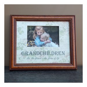 dark frame with a photo of grandchildren in a decorated photo mount