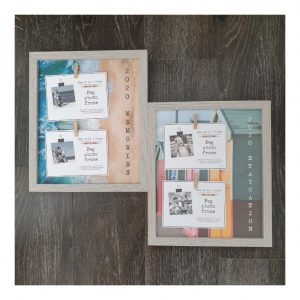 Grey frames with 2 pegs for photos and beach huts and sand and sea backgrounds