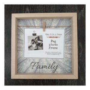 Light wooden photo frame with peg and string, tree background and family text