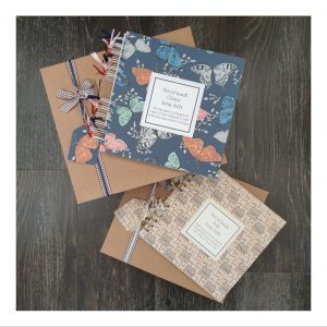 2 scrapbooks with butterfly and cat designs for colleagues leaving work