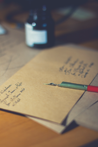 an envelope with inkpen and ink