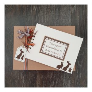 cream scrapbook with brown rabbits silhouettes sitting on a kraft brown gift box